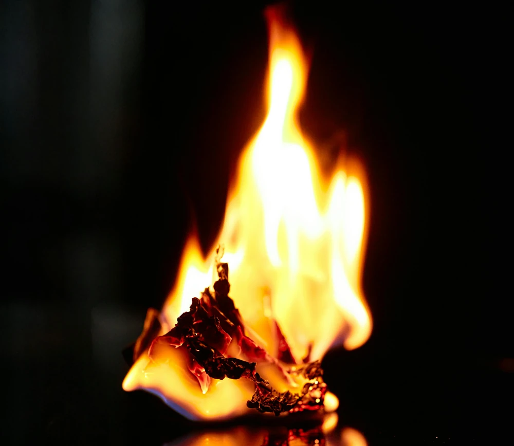 Burning paper on a dark background